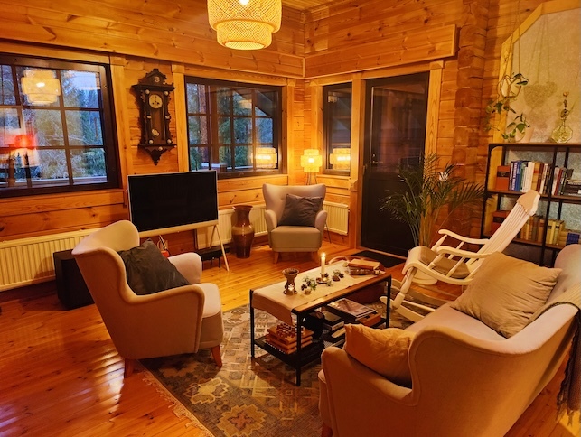 Wooden ppstairs lounge with sofa, armchairs and traditional rocking chair. 